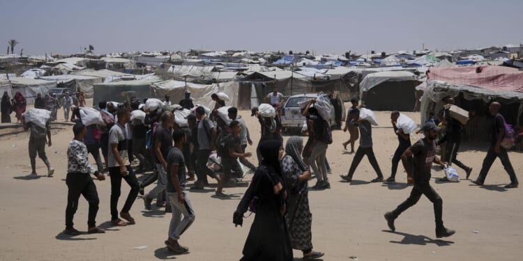 Israel says it fired warning shots and Palestinians say Israeli fire kills 5 near aid sites