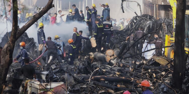Search and rescue teams respond to the scene of a plane crash Thursday in Ahmedabad, India.