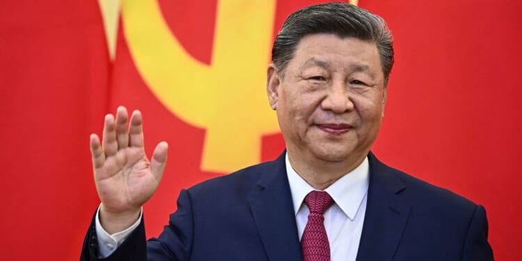 Chinese President Xi Jinping waves during a meeting with Vietnam's Communist Party General Secretary To Lam at the Office of the Party Central Committee in Hanoi on April 14, 2025.