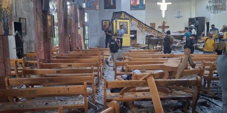 Journalists and Civil Defense workers inspect the damage inside Mar Elias church where a suicide bomber detonated himself in Damascus, Syria, on Sunday.