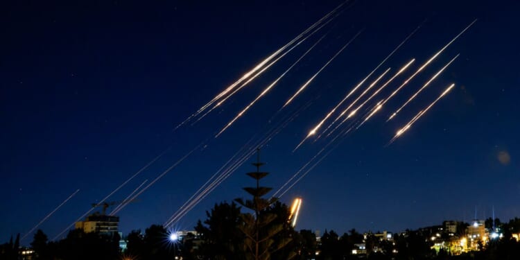 Missiles fired from Iran are pictured in the night sky over Jerusalem on June 14, 2025.
