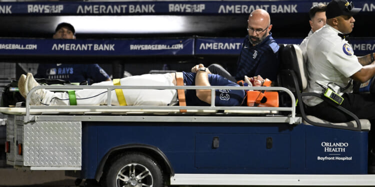 Tampa Bay Rays' Hunter Bigge is taken off the field after being hit by a foul ball while in the dugout during the seventh inning of a baseball game against the Baltimore Orioles in Tampa, Florida, on Thursday.