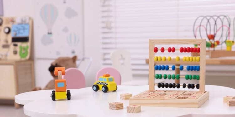 Different toys on a table in a playroom.