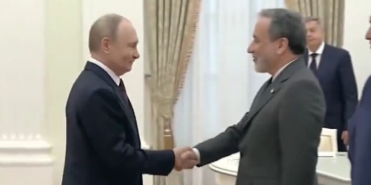 Russian President Vladimir Putin, left, greets Iranian Foreign Minister Abbas Araghchi, right, in Moscow on Monday.