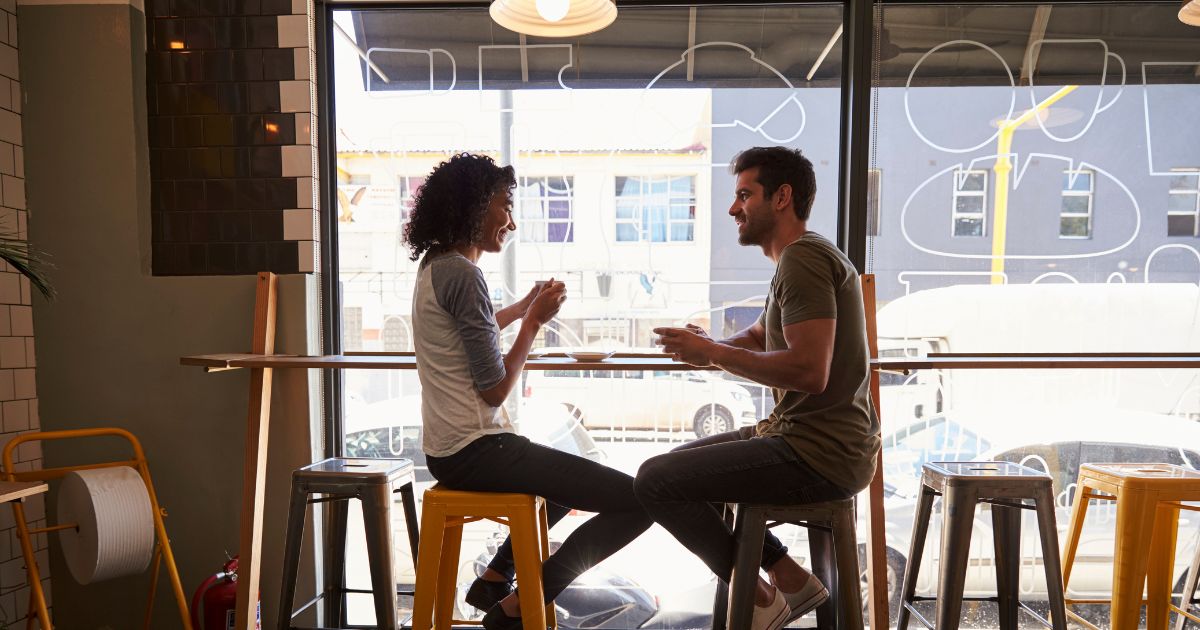A couple meeting for a date in a coffee shop.