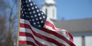 An American flag flies in the wind in a New Jersey churchyard.