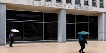 Workers are seen leaving the Department of Education building in Washington, D.C., in a file photo taken May 21.