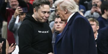 Elon Musk, left, and President Donald Trump, right, shake hands as they attend the men's NCAA wrestling competition in Philadelphia, Pennsylvania, on March 22.