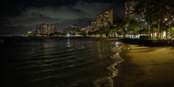 Waves roll onto an empty beach in Waikiki, Hawaii, on Tuesday.