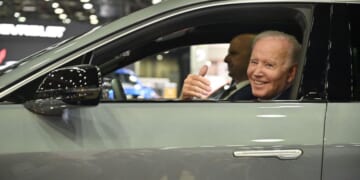 Then-President Joe Biden sits at the wheel of a Cadillac Lyriq electric vehicle as he visits the North American International Auto Show in Detroit, Michigan, on Sept. 14, 2022.