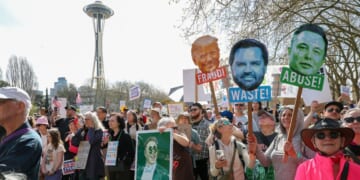 Demonstrators attend the nationwide "Hands Off!" protest against President Donald Trump and Tesla CEO Elon Musk at the Seattle Center on April 5, 2025, in Seattle, Washington.