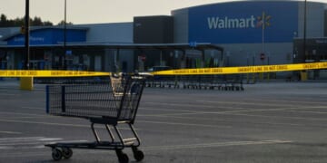 A shopping cart holds police tape at the scene of a violent crime where multiple individuals were stabbed at a Michigan Walmart on July 26, 2025.