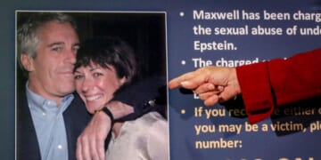 U.S. Attorney for the Southern District of New York Audrey Strauss presents a photo of Jeffrey Epstein and Ghislaine Maxwell during a news conference.