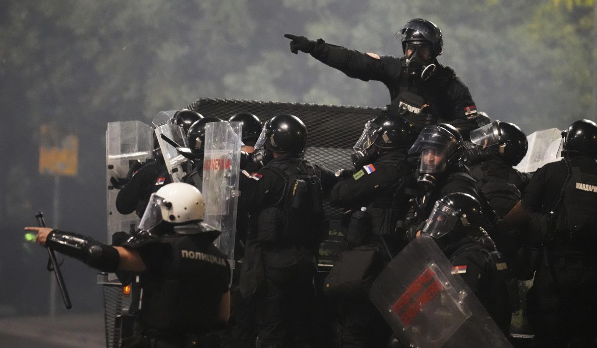 Tensions soar in Serbia as angry protesters clash with police, set fire to party offices
