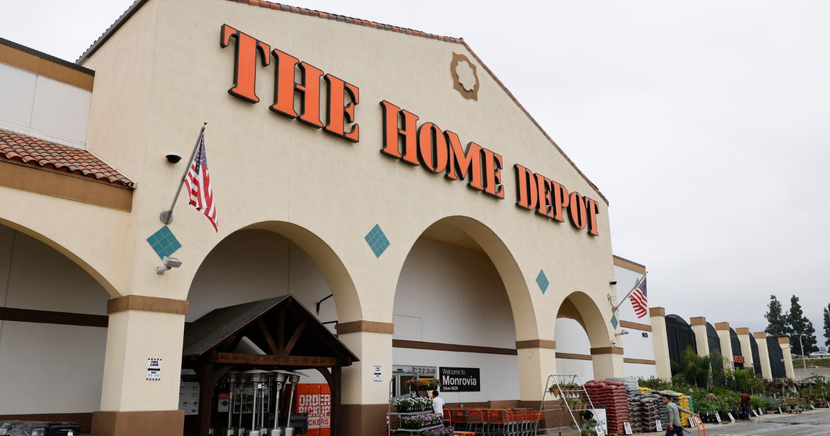 People make their way out to the parking lot of the Monrovia Home Depot next to where a man was hit and killed on the 210 Freeway on Thursday as he tried to flee federal agents raiding the business on Friday, Aug. 15, 2025, in Monrovia, California.