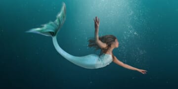 This image depicts a mermaid swimming in the ocean.