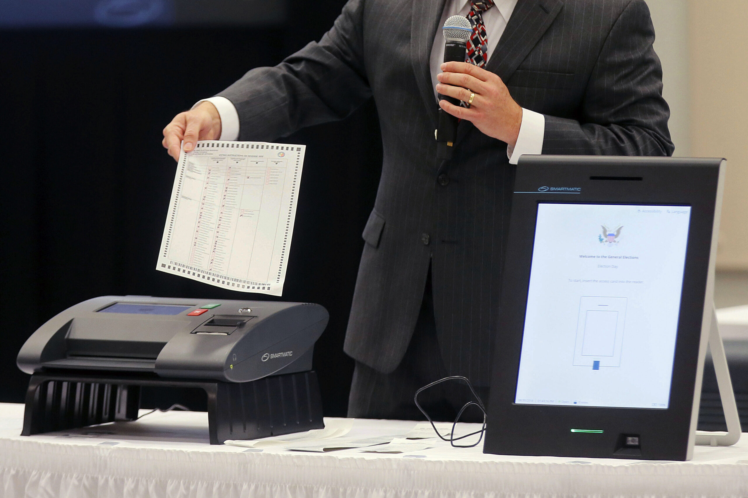 A Smartmatic representative demonstrates his company's system at a meeting of the Secure, Accessible & Fair Elections Commission on Aug. 30, 2018, in Grovetown, Georgia.