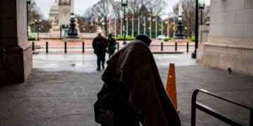 A homeless person walks out of Union Station as the train station is almost deserted by commuters during the usual rush hour in Washington, D.C., on March 25, 2020.