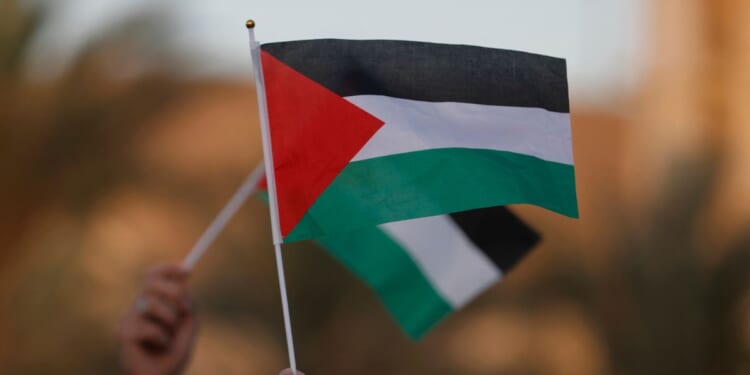 Iraqi citizens raise Palestinian flags during an anti-Israel rally in Baghdad on Sept. 23, 2025.