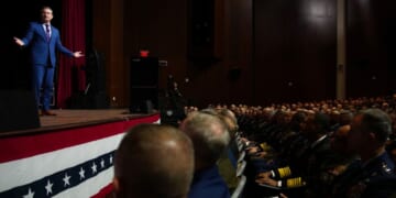Secretary of War Pete Hegseth, left, speaks to senior military leaders at Marine Corps Base Quantico in Quantico, Virginia, on Tuesday.