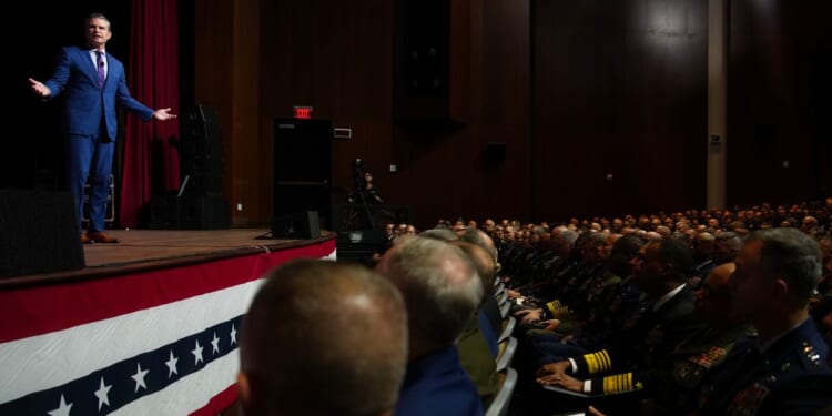 Secretary of War Pete Hegseth, left, speaks to senior military leaders at Marine Corps Base Quantico in Quantico, Virginia, on Tuesday.