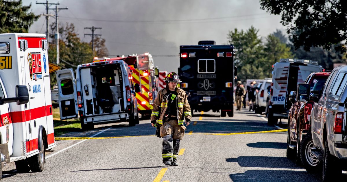 A firefighter walks down the street near the Church of Jesus Christ of Latter-day Saints that was attacked on Sept. 28, 2025 in Grand Blanc, Michigan.