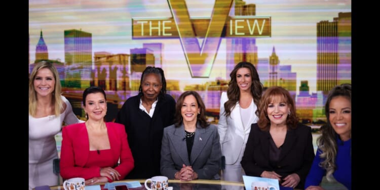 The cast of "The View" huddles around former Vice President Kamala Harris in New York on Oct. 8, 2024.