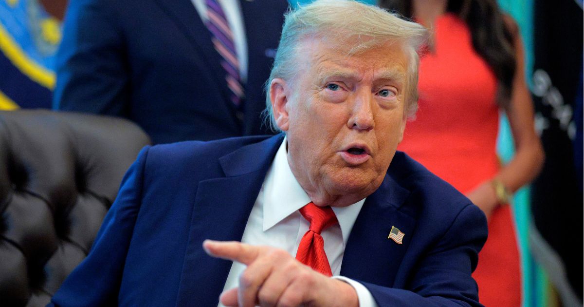 President Donald Trump talks to journalists after signing executive orders in the Oval Office at the White House on Aug. 25.