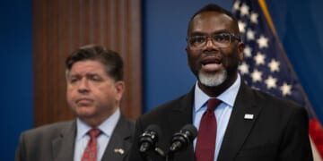 Illinois Gov. J.B. Pritzker listens as Chicago Mayor Brandon Johnson speaks at a news conference on Oct. 6, 2025, in Chicago, Illinois.