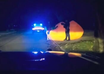 Video of police pursuit of a huge inflatable pumpkin shows officer struggling with it