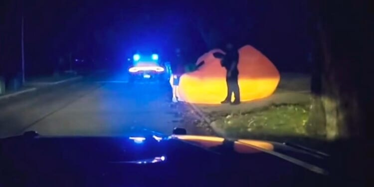 Video of police pursuit of a huge inflatable pumpkin shows officer struggling with it