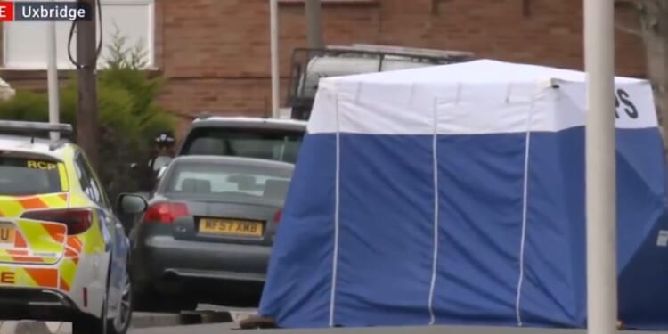London police investigators set up a tent over the crime scene.