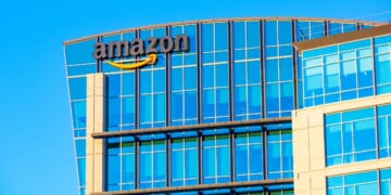 The Amazon logo is displayed on the glass exterior of Amazon.com office in Sunnyvale, California, in 2021.