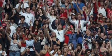 Attendees at a memorial service for Charlie Kirk sing worship songs before the beginning of the service in Glendale, Arizona, on Sept. 21.