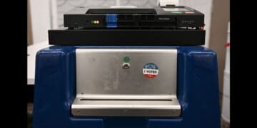 An "I Voted" sticker is displayed on the side of a box beneath a Dominion Voting Machines tabulator in Phoenix, Arizona, on June 3, 2024.