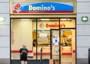 A person wears a protective face mask outside Domino's Pizza in Kips Bay as New York City on July 9, 2020.