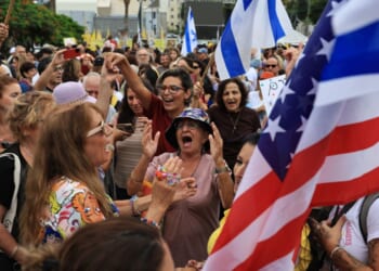 Israelis celebrate with Israeli and American flags as they react to the news of the Gaza peace deal at Hostages Square in Tel Aviv, Israel, on Thursday.