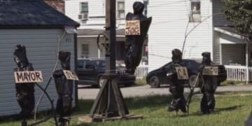 The display featured a gallows and several body bags with signs depicting the titles of local government officials.