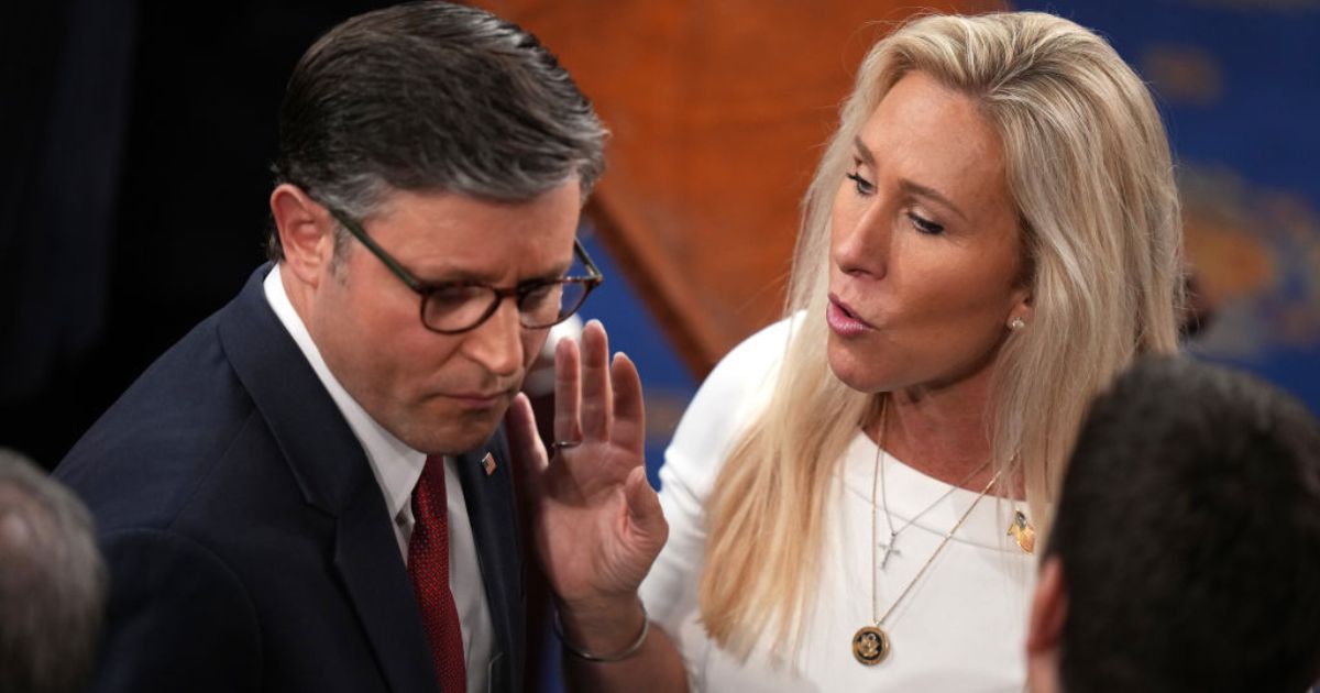 House Speaker Mike Johnson of Louisiana, seen with fellow Republican Rep. Marjorie Taylor Greene of Georgia in a January photo, clashed over the government shutdown during a conference call Tuesday.