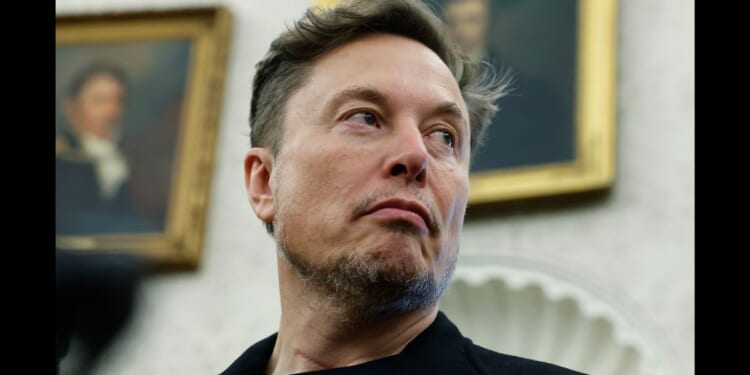Elon Musk listens as reporters ask President Donald Trump questions at the White House in Washington, DC on May 21, 2025.