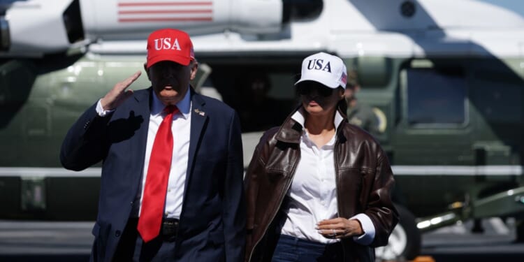 President Donald Trump and first lady Melania Trump arrive on the deck of the USS George H.W. Bush aircraft carrier in Naval Station Norfolk, Virginia, on Sunday.