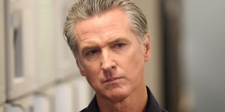 Gov. Gavin Newsom listens before speaking during a news conference in Los Angeles, California, on Thursday.