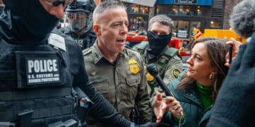 Border Patrol commander Gregory Bovino pushes through a crowd of media and protesters as he enters the Dirksen Federal Building Tuesday in Chicago, Illinois.