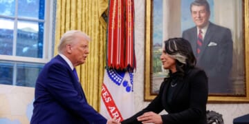 Director of National Intelligence Tulsi Gabbard shakes hands with President Donald Trump in the Oval Office at the White House on Feb. 12, 2025, in Washington, D.C.