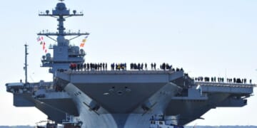 In this handout photo provided by the U.S. Navy, sailors aboard the aircraft carrier Pre-Commissioning Unit Gerald R. Ford man the rails as the ship departs Huntington Ingalls Industries Newport News Shipbuilding for builder's sea trials off the U.S. East Coast on April 8, 2017, in Newport News, Virginia.