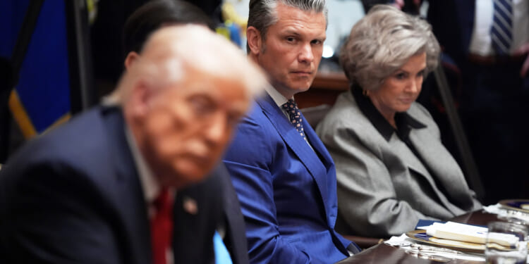 Defense Secretary Pete Hegseth listens as he and White House Chief of Staff Susie Wiles, right, listen during a meeting Monday with President Donald Trump, in foreground left, and Australian Prime Minister Anthony Albanese at the White House in Washington, D.C.