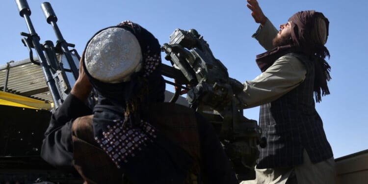 Armed Taliban forces watch the sky for Pakistani airstrikes during ongoing clashes between Taliban forces and Pakistani border forces in the Kandahar Province on Wednesday.