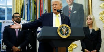 President Donald Trump, center, speaks to reporters during a news conference in the Oval Office of the White House in Washington, D.C., on Wednesday.
