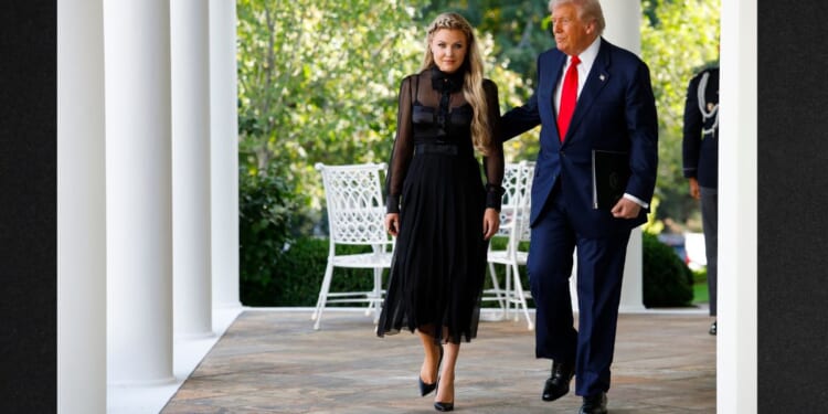 President Donald Trump escorts Erika Kirk, wife of late conservative activist Charlie Kirk, to a ceremony Tuesday in which he posthumously awarded the Presidential Medal of Freedom to Charlie Kirk during a ceremony in the Rose Garden of the White House.