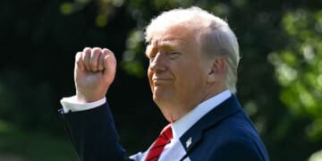 President Donald Trump raises his fist on the South Lawn of the White House in Washington, DC on Oct. 10, 2025.